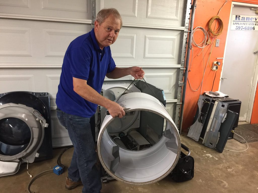 Raney Appliance Service technician working on an appliance